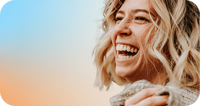 Woman with curly blonde hair laughing
